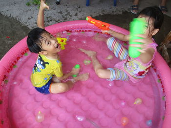 Cute girl playing with pink umbrella