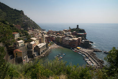 High angle view of buildings by sea against sky