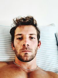 Portrait of handsome young man on bed