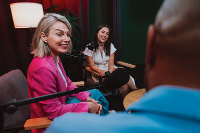 Portrait of young woman sitting on bed