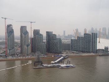 Aerial view of bay and buildings against sky