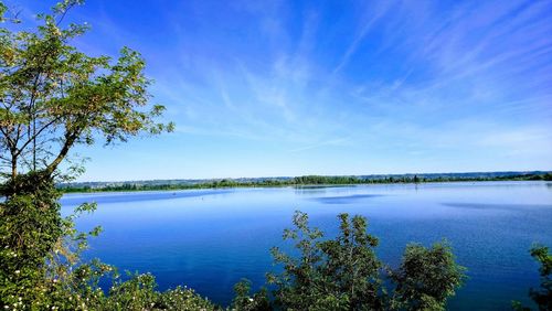 Scenic view of lake against blue sky