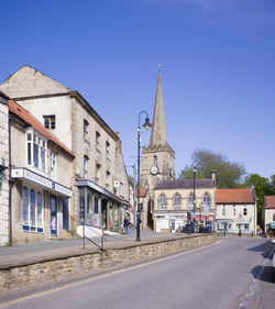 View of buildings against clear blue sky