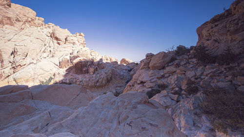 Rock formations on mountain against clear sky