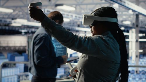 Rear view of woman standing against building