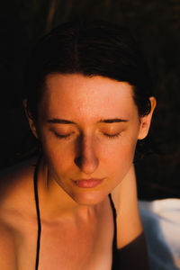 Close-up of young woman in darkroom