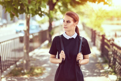 Portrait of young woman standing outdoors