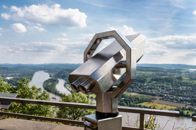 A paid binocular telescope, set on a high vantage point with a view of the city.