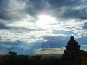 Low angle view of statue against cloudy sky