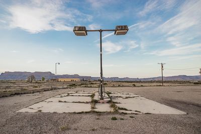 Street light on road against sky