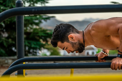 Close-up of young man wearing exercising outdoors