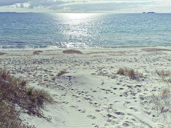 View of calm sea against cloudy sky