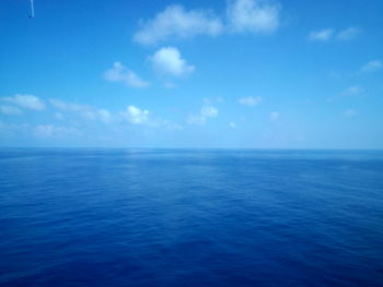 Scenic view of sea against blue sky