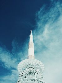 Low angle view of tower against blue sky