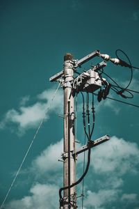 Low angle view of electricity pylon against sky