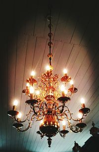 Low angle view of illuminated chandelier against sky