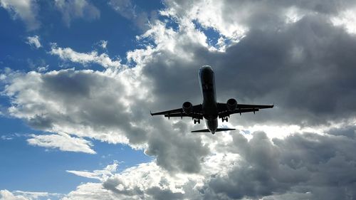 Low angle view of airplane flying in sky