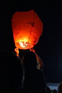 Close-up of light bulb over black background