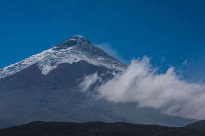 Scenic view of mountains against clear blue sky