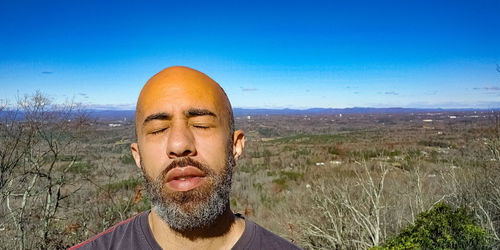 Portrait of man wearing sunglasses against sky