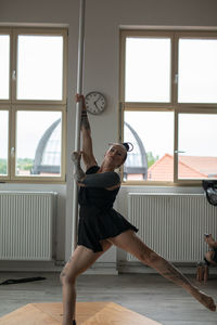 Side view of woman exercising at gym