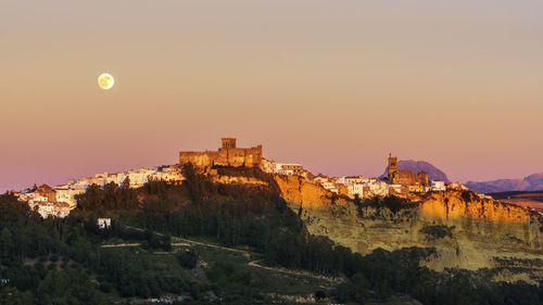 Buildings against sky during sunset