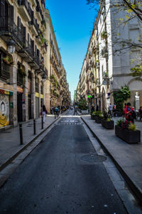 Narrow street amidst buildings in city