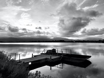 Pier on lake against sky