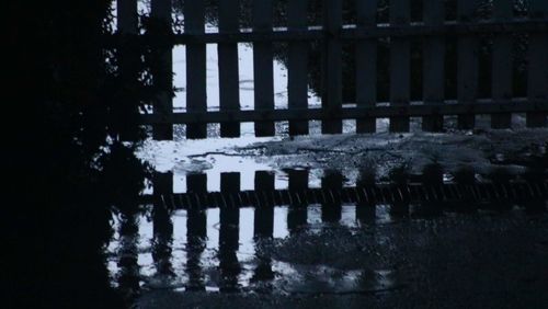 Reflection of frozen lake in puddle during winter