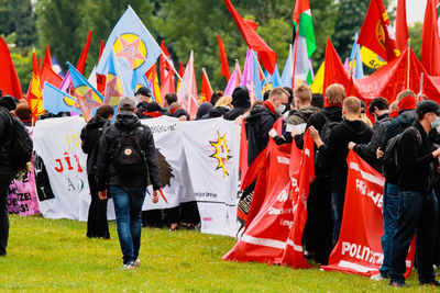 Rear view of people walking in colorful flags