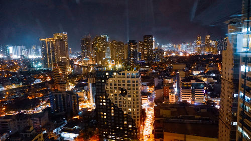 High angle view of illuminated buildings in city at night