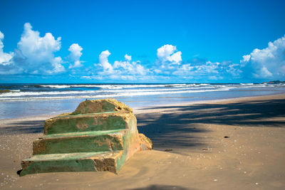 Scenic view of beach against blue sky