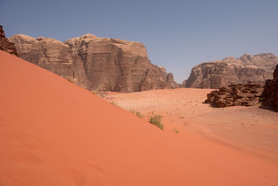 Sand dunes and sandstone cliffs in wadi rum desert , jordan