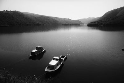 Boats moored in river