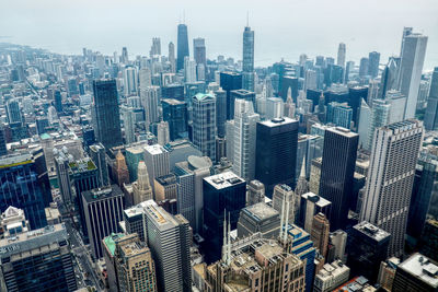 Aerial view of modern buildings in city against sky