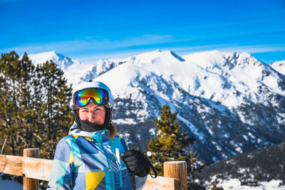 Portrait of young woman, looking at camera, with snowy pyrenees mountains in a background, andorra