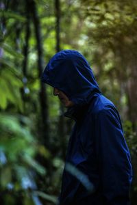 Portrait of man wearing hat in forest