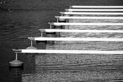 Side view of jetty in rows at rippled water