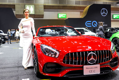 Portrait of woman standing in car