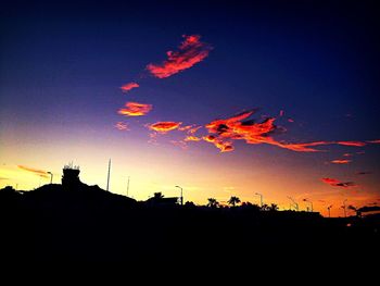 Low angle view of silhouette built structures against sky