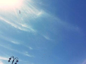 Low angle view of airplane flying against sky