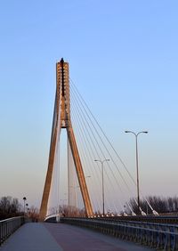 Low angle view of suspension bridge against sky