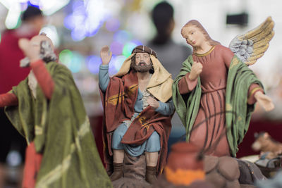 Close-up of jesus and angel figurines