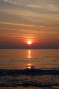 Scenic view of sea against romantic sky at sunset