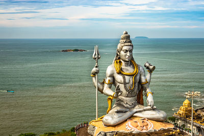 Shiva statue isolated at murdeshwar temple aerial shots with arabian sea in the backdrop