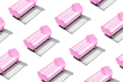 Pattern of pink baby crib isolated on white background. female births concept
