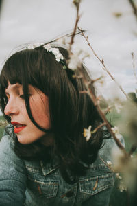 Portrait of young woman with plants