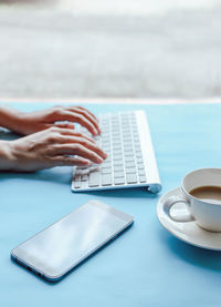 Midsection of coffee cup on table