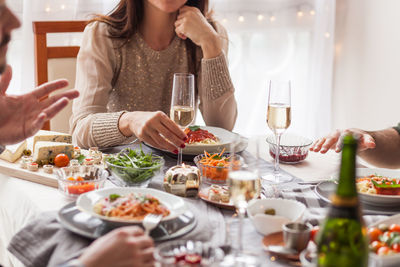 Midsection of people having food at table