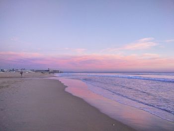 Scenic view of beach against dramatic sky